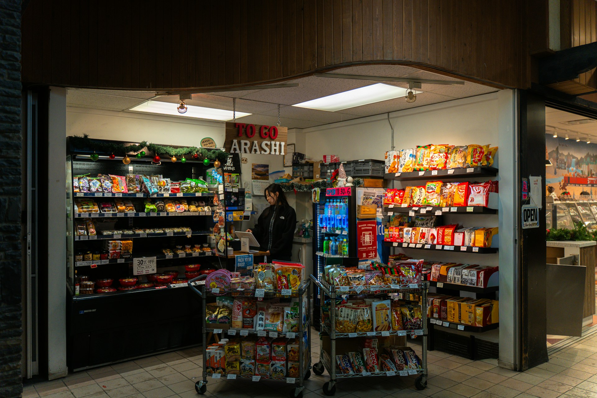 Inside a convenience store — shelves stocked, counter ready